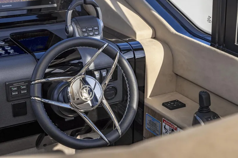 Slide: The Image of 2025 Cruisers Yachts 57 Fly helm with modern steering wheel and controls. - 37