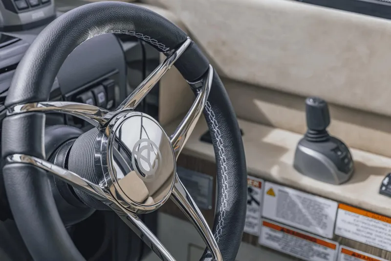 Slide: The Image of Steering wheel and controls of 2025 Cruisers Yachts 57 Fly, showcasing luxury design. - 38