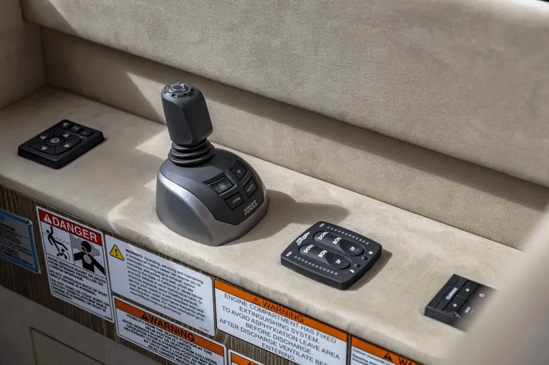 Slide: The Image of 2025 Cruisers Yachts 57 Fly control panel with joystick and warning labels. - 39