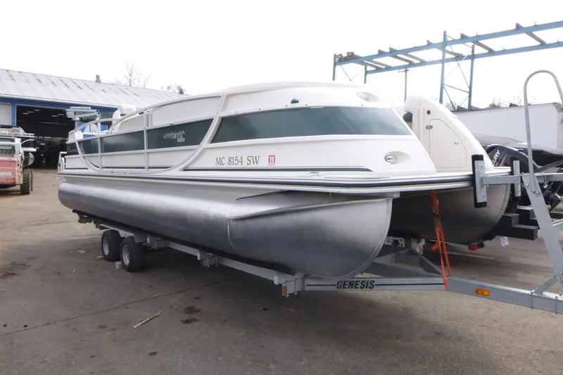 Slide: The Image of 2006 Harris FloteBote Crowne 250 pontoon boat on trailer in a storage yard. - 3