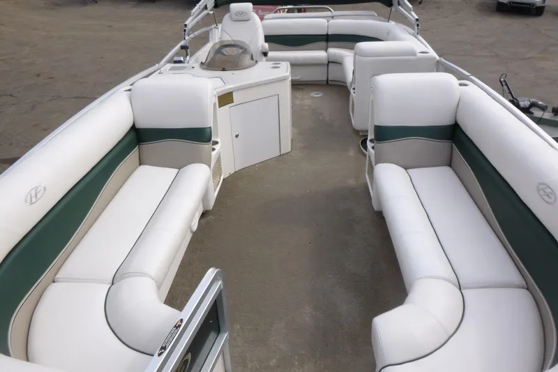 Slide: The Image of 2006 Harris FloteBote Crowne 250 pontoon boat with spacious white and green seating. - 4