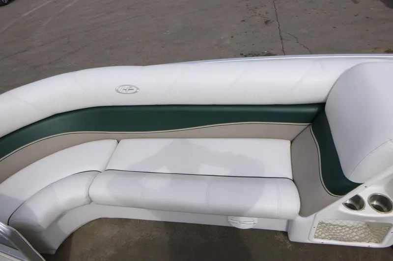 Slide: The Image of Luxurious seating on 2006 Harris FloteBote Crowne 250 pontoon boat, featuring white and green upholstery. - 7