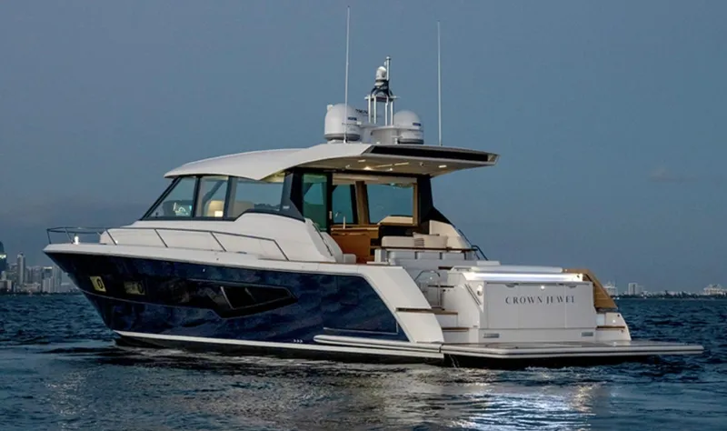 The Image of 2024 Tiara Yachts EX 60 luxury yacht on the water at dusk. - 0