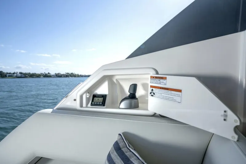 Slide: The Image of Control panel of the 2024 Tiara Yachts EX 60 with scenic water view. - 10
