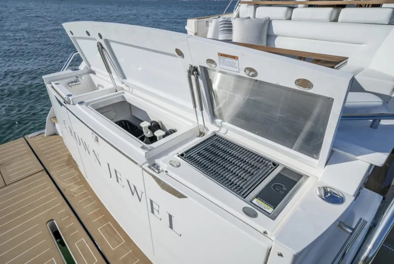 Slide: The Image of 2024 Tiara Yachts EX 60 outdoor kitchen with grill and storage compartments. - 18
