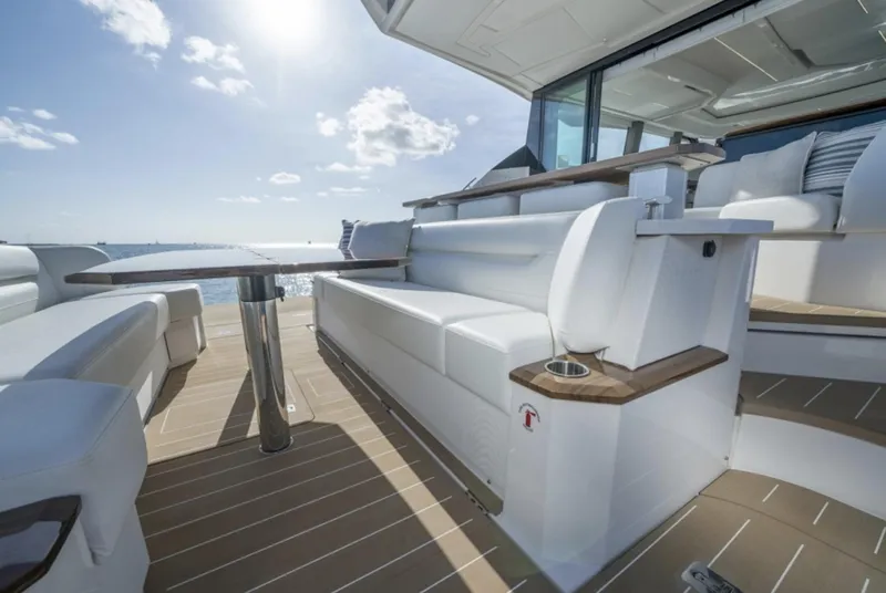 Slide: The Image of 2024 Tiara Yachts EX 60 luxury deck with seating and ocean view. - 20