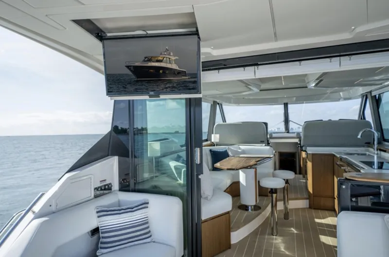 Slide: The Image of 2024 Tiara Yachts EX 60 interior, luxury yacht with modern seating and ocean view. - 25