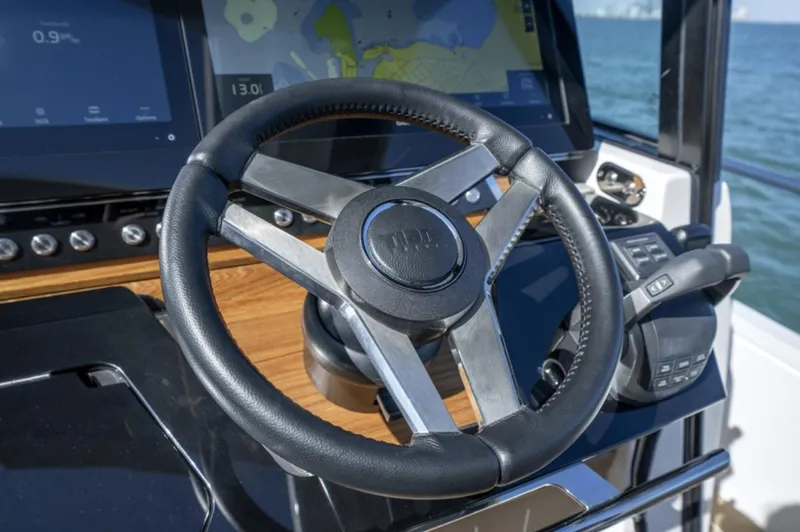 Slide: The Image of Steering wheel and dashboard of 2024 Tiara Yachts EX 60 with navigation screens. - 34