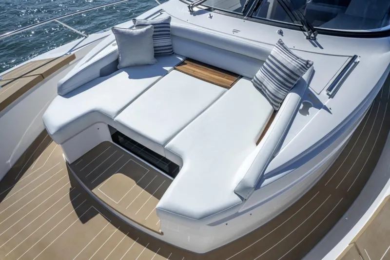 Slide: The Image of 2024 Tiara Yachts EX 60 bow seating area with cushions and teak accents. - 4