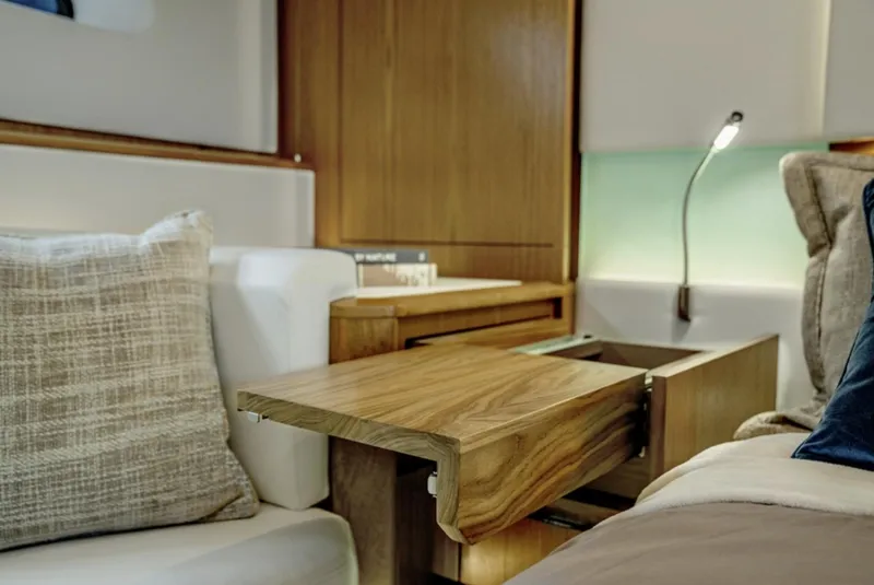 Slide: The Image of Interior of 2024 Tiara Yachts EX 60 with wooden table and cozy seating. - 43