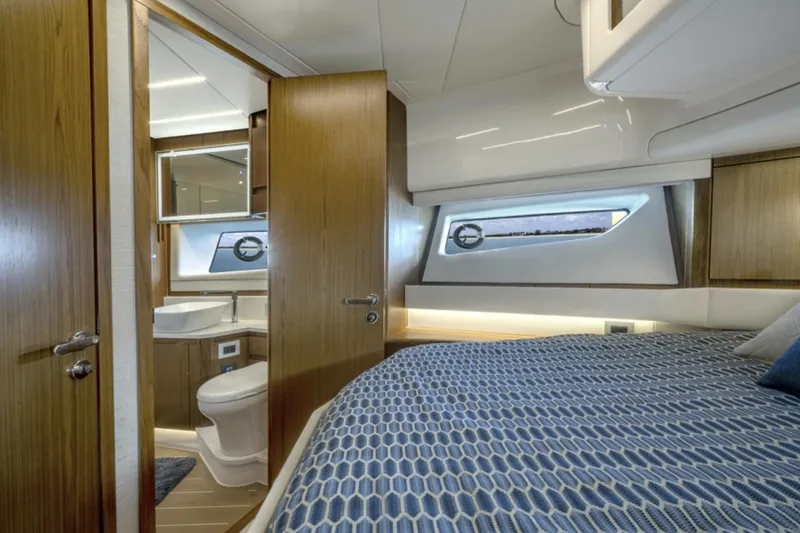 Slide: The Image of 2024 Tiara Yachts EX 60 interior cabin with bed and bathroom. - 46
