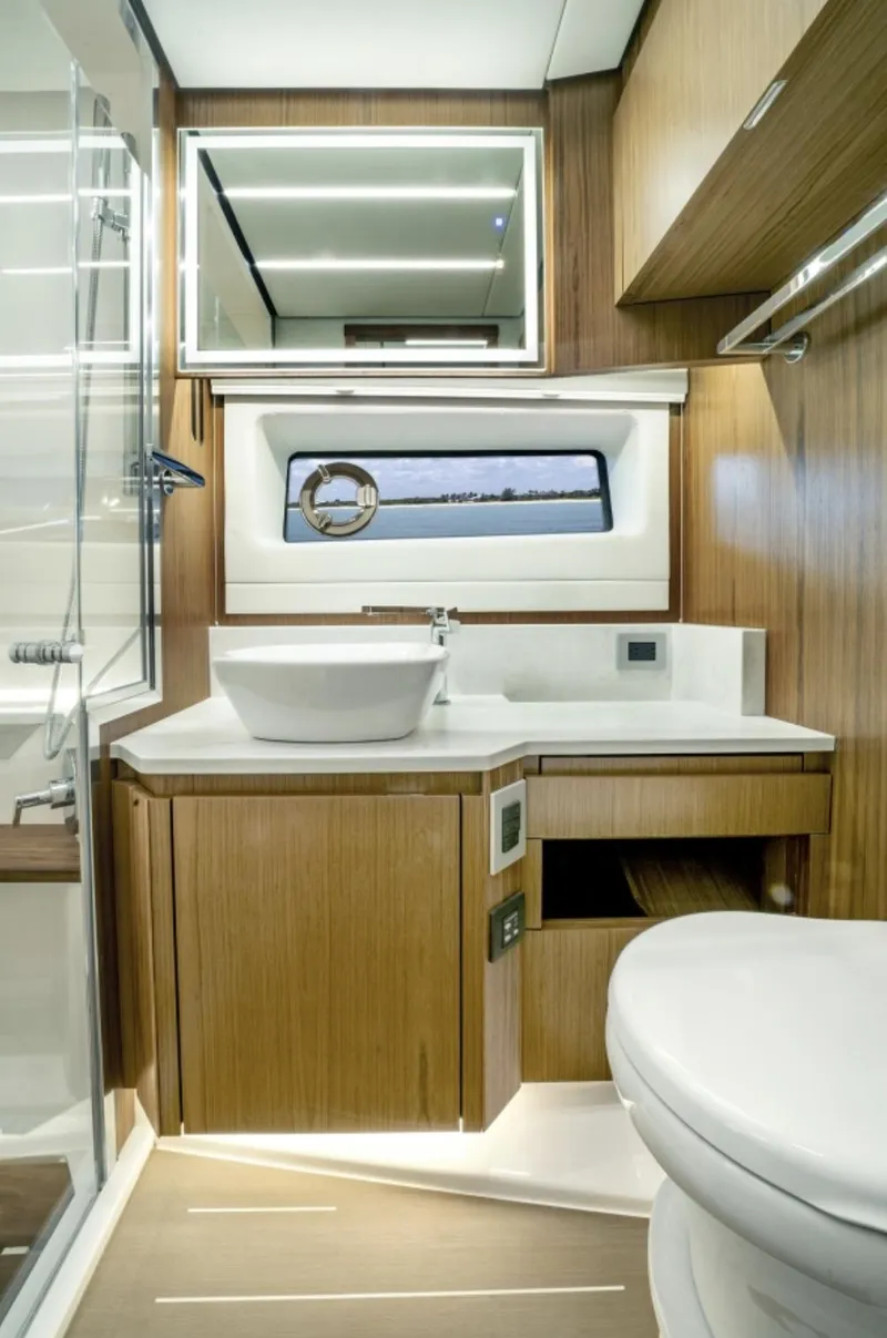 Slide: The Image of Modern bathroom in 2024 Tiara Yachts EX 60 with sleek wood finishes. - 48