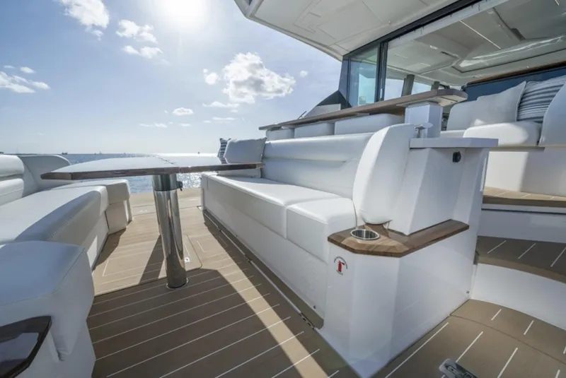 Slide: The Image of 2024 Tiara Yachts EX 60 deck with luxurious seating and ocean view. - 6