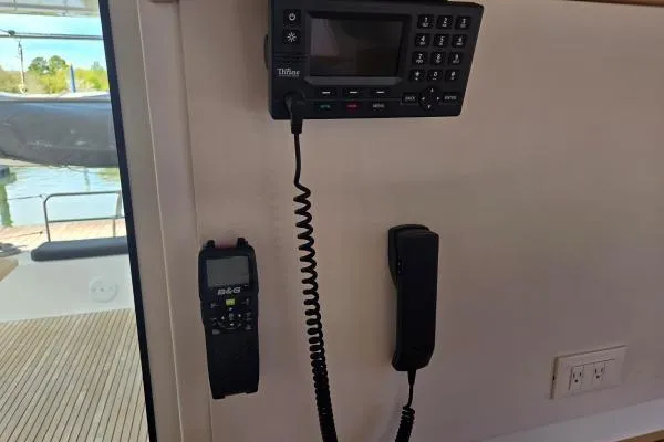 Slide: The Image of Interior communication equipment on a 2018 Lagoon 42 catamaran, featuring a radio and handset. - 15