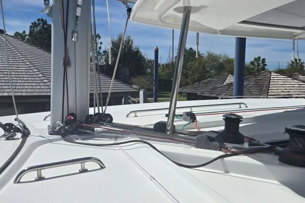 Slide: The Image of 2018 Lagoon 42 catamaran deck with rigging and winches under clear sky. - 19