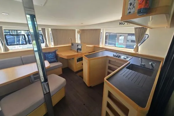 Slide: The Image of Interior of 2018 Lagoon 42 catamaran featuring modern kitchen and dining area with ample seating. - 3