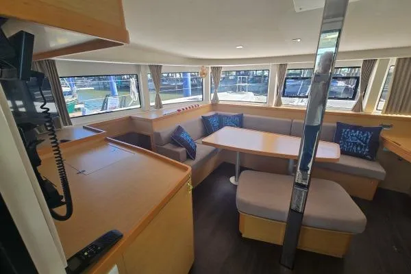 Slide: The Image of Spacious interior of 2018 Lagoon 42 catamaran with dining area and large windows. - 4