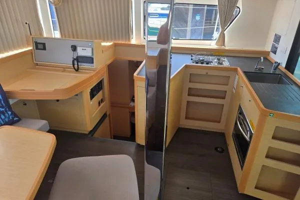 Slide: The Image of Interior of a 2018 Lagoon 42 catamaran featuring a modern kitchen and navigation area. - 6