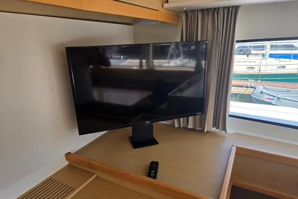 Slide: The Image of Flat-screen TV in 2018 Lagoon 42 yacht interior, near window with marina view. - 7