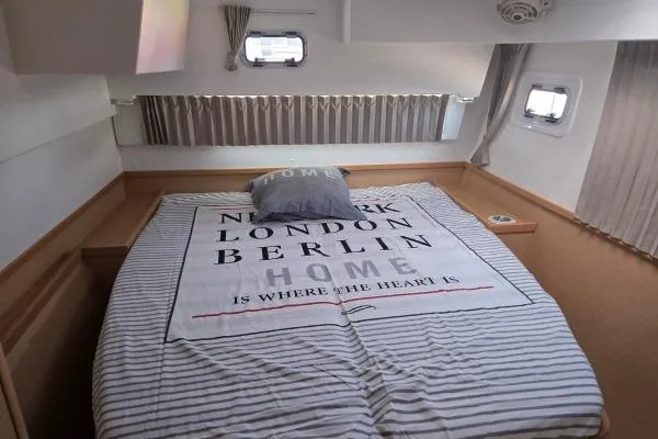 Slide: The Image of Cozy bedroom interior of 2018 Lagoon 42 catamaran with nautical-themed bedding. - 8