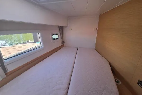 Slide: The Image of Interior cabin of 2018 Lagoon 42 catamaran with twin beds and window view. - 9