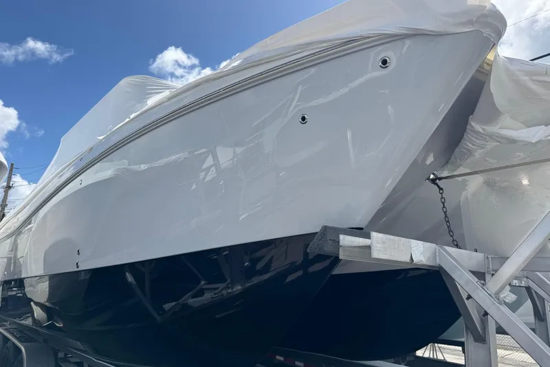 The Image of 2026 World Cat 325 CC boat on trailer under blue sky. - 0