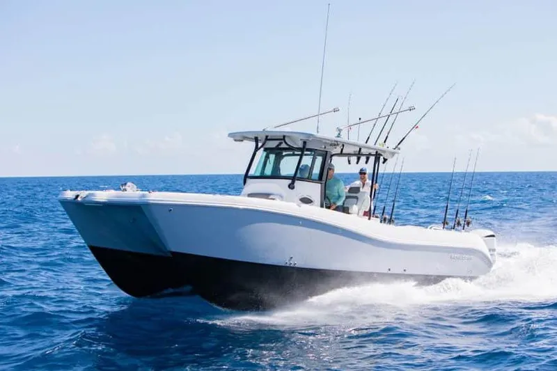 Slide: The Image of Manufacturer Provided Image: 2026 World Cat 325 CC boat cruising on open ocean, equipped with fishing rods. - 14