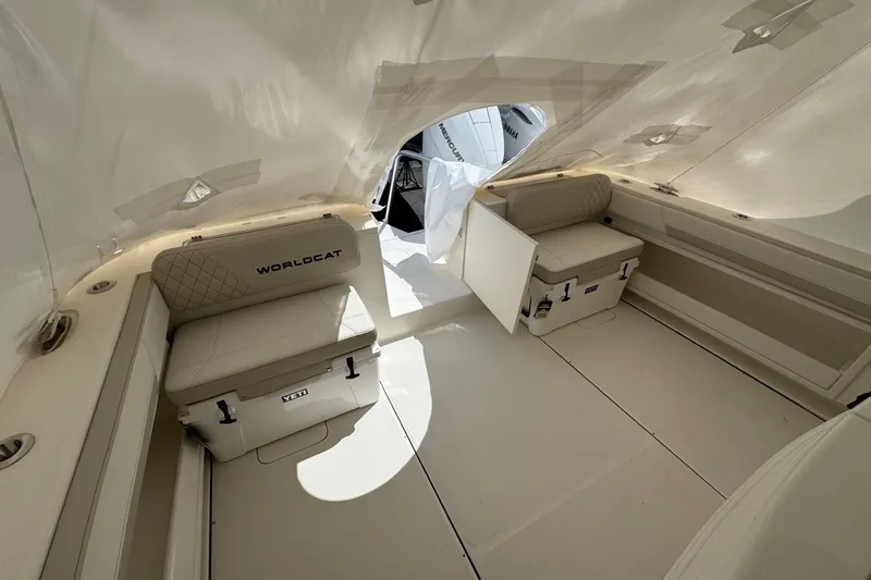 Slide: The Image of Interior of 2026 World Cat 325 CC boat with cushioned seating and storage. - 15