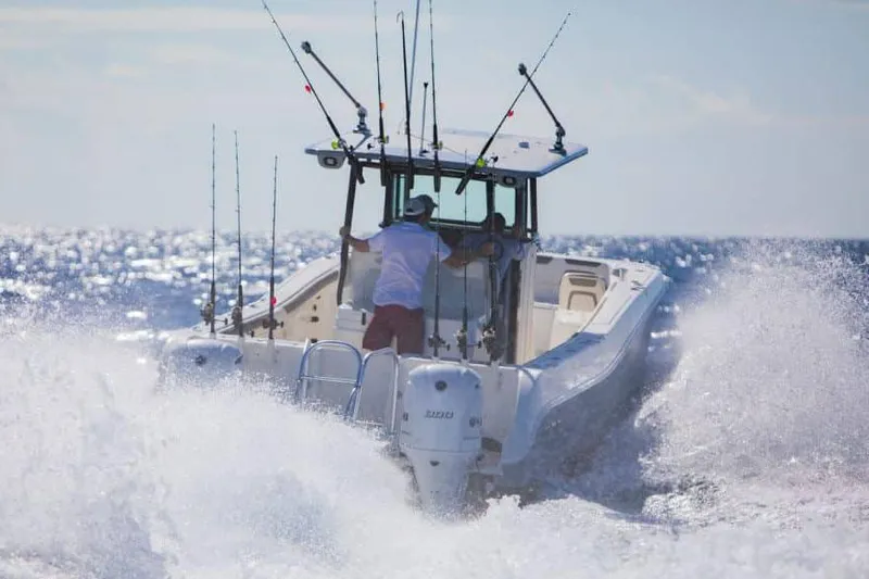Slide: The Image of Manufacturer Provided Image: 2026 World Cat 325 CC boat navigating ocean waves, equipped with fishing rods. - 20