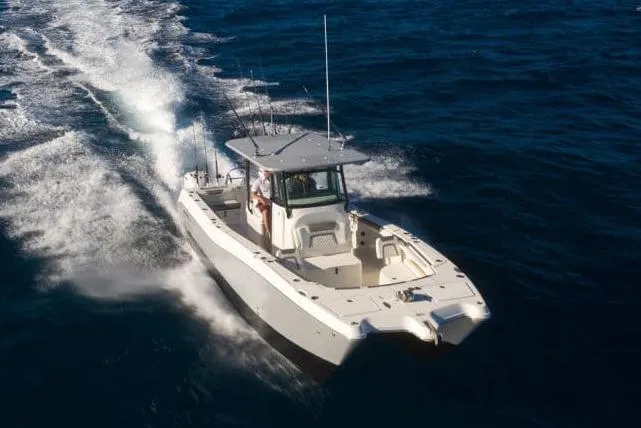 Slide: The Image of Manufacturer Provided Image: 2026 World Cat 325 CC cruising on open water, showcasing sleek design and performance. - 21