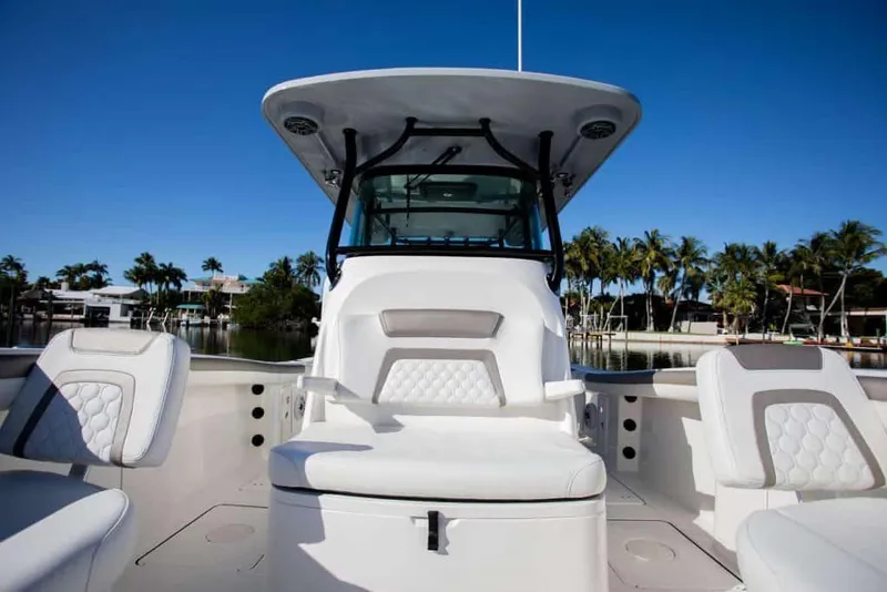 Slide: The Image of Manufacturer Provided Image: 2026 World Cat 325 CC boat with sleek seating and modern design, docked near palm trees. - 25