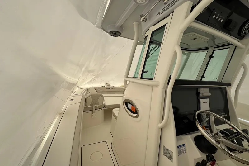 Slide: The Image of Interior view of 2026 World Cat 325 CC boat, featuring helm and seating area. - 6