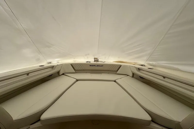 Slide: The Image of Interior view of 2026 World Cat 325 CC boat with beige seating and sleek design. - 9