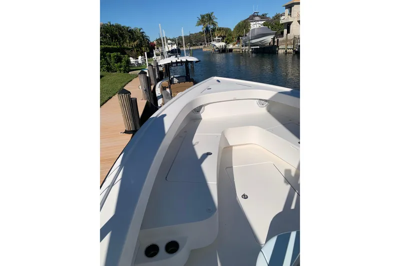 Slide: The Image of White interior of a 2015 Stuart 26 boat featuring dual cup holders. - 13