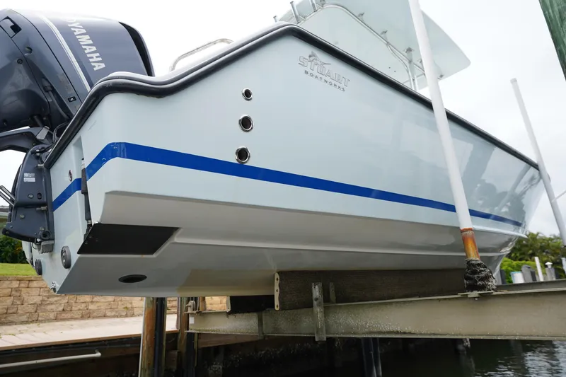 Slide: The Image of Stuart 26 boat from 2015 on lift, featuring Yamaha engine. - 24
