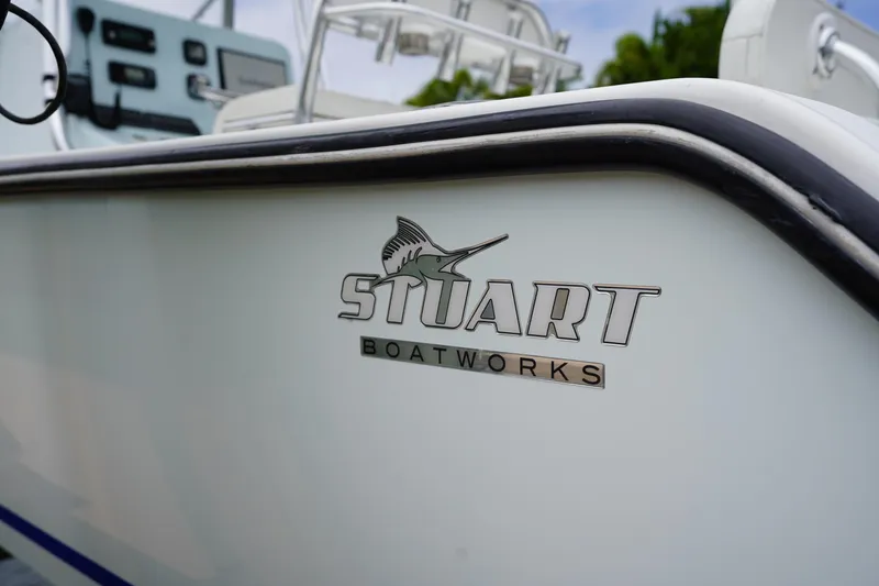 Slide: The Image of Close-up of a 2015 Stuart 26 boat with logo and sleek design. - 27