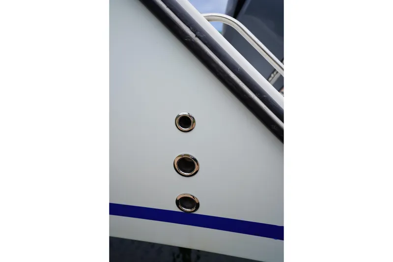 Slide: The Image of Close-up of a 2015 Stuart 26 boat hull with three chrome fittings. - 28