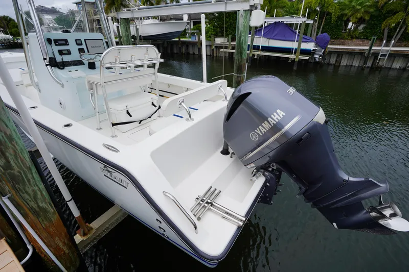 Slide: The Image of Stuart 26 boat with Yamaha engine docked in a marina, 2015 model. - 29