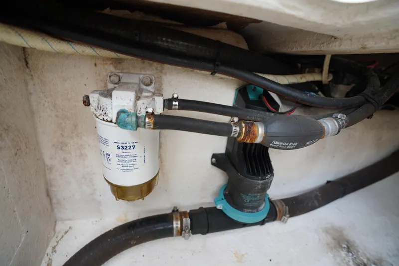 Slide: The Image of Engine compartment of a 2015 Stuart 26, featuring fuel filter and hoses. - 32