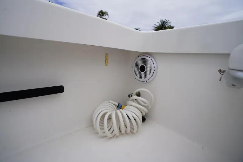 Slide: The Image of Coiled hose and speaker on 2015 Stuart 26 boat deck. - 34