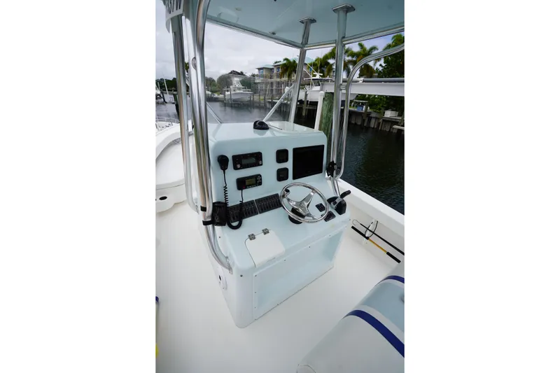Slide: The Image of Steering console of a 2015 Stuart 26 boat, featuring navigation equipment and controls. - 41