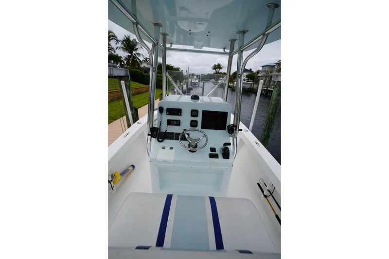 Slide: The Image of Center console of a 2015 Stuart 26 boat with steering wheel and controls. - 42