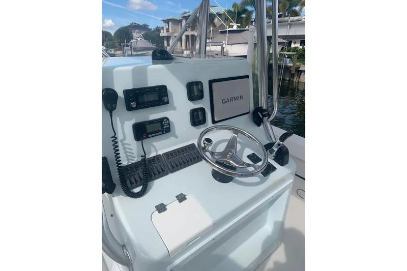 Slide: The Image of Stuart 26 boat from 2015 on a lift by a waterfront home. - 5