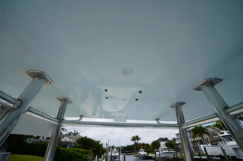Slide: The Image of View from under the T-top of a 2015 Stuart 26 boat, showing metal supports. - 53