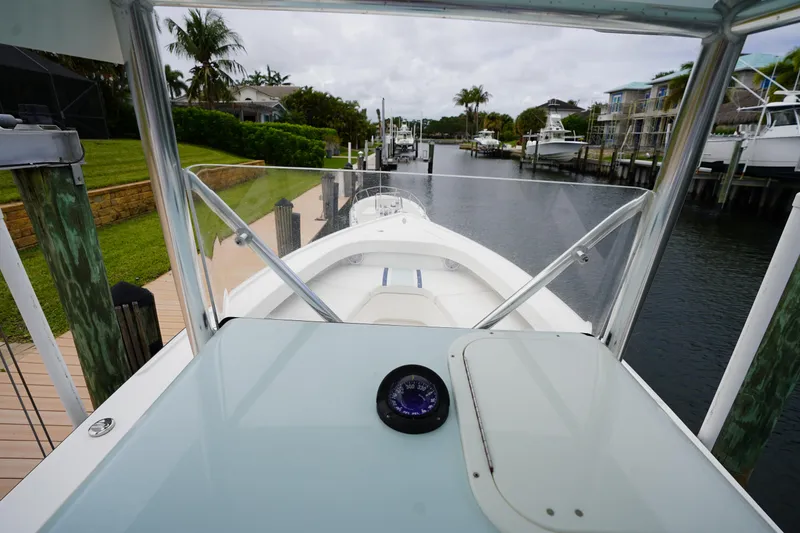Slide: The Image of Cockpit view of 2015 Stuart 26 boat docked in a scenic marina. - 54