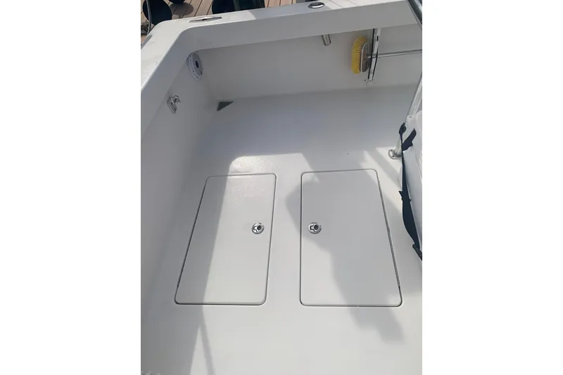 Slide: The Image of Stuart 26 boat from 2015 on a lift, docked by palm trees. - 7