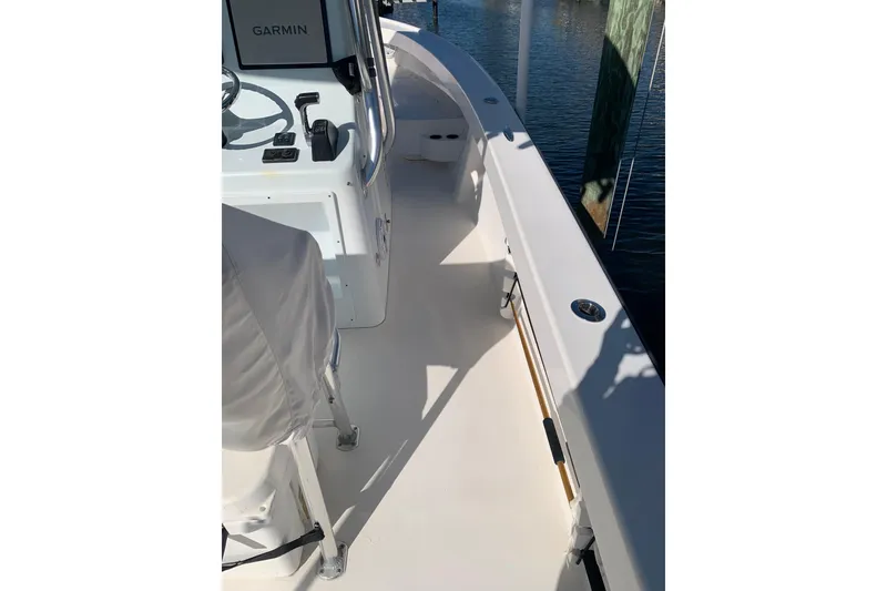 Slide: The Image of 2015 Stuart 26 boat interior with Garmin navigation, docked by water. - 14