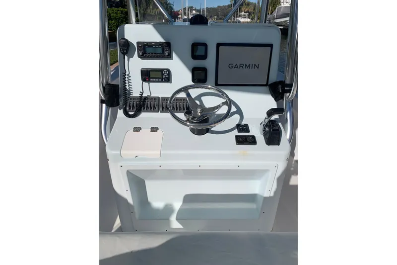 Slide: The Image of Boat console of a 2015 Stuart 26 with Garmin navigation system and steering wheel. - 6