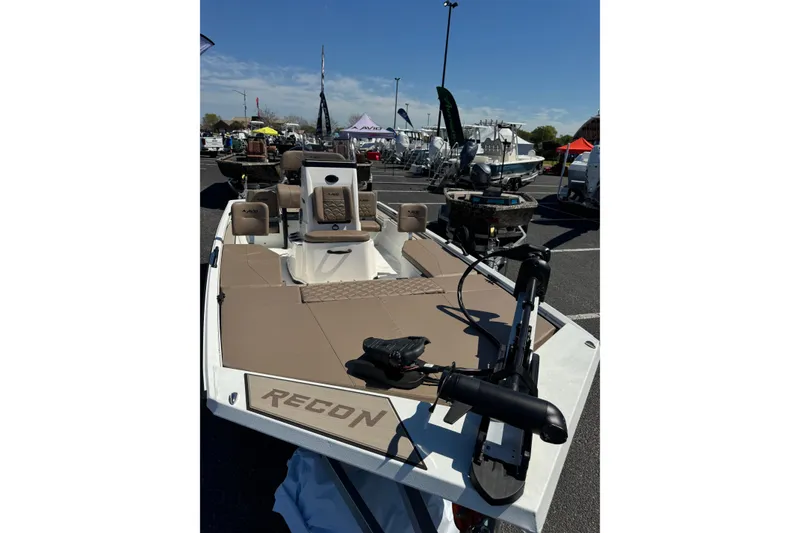 Slide: The Image of 2026 Avid 207 Recon boat displayed outdoors, featuring a sleek design and modern equipment. - 2