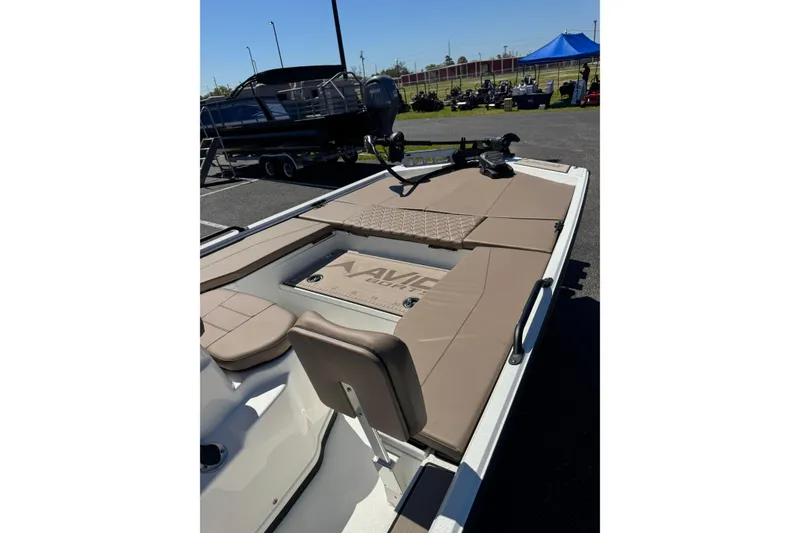 Slide: The Image of 2026 Avid 207 Recon boat with tan seating and deck, displayed outdoors. - 3